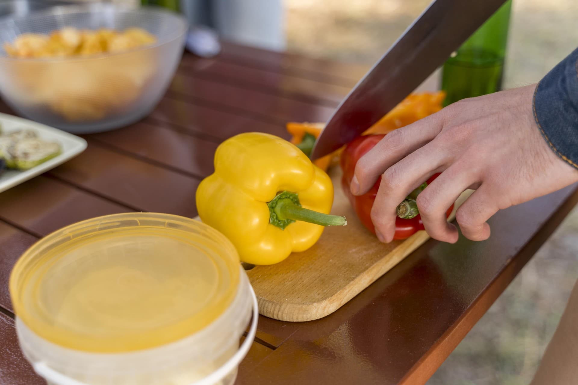 person cutting vegetables barbecue